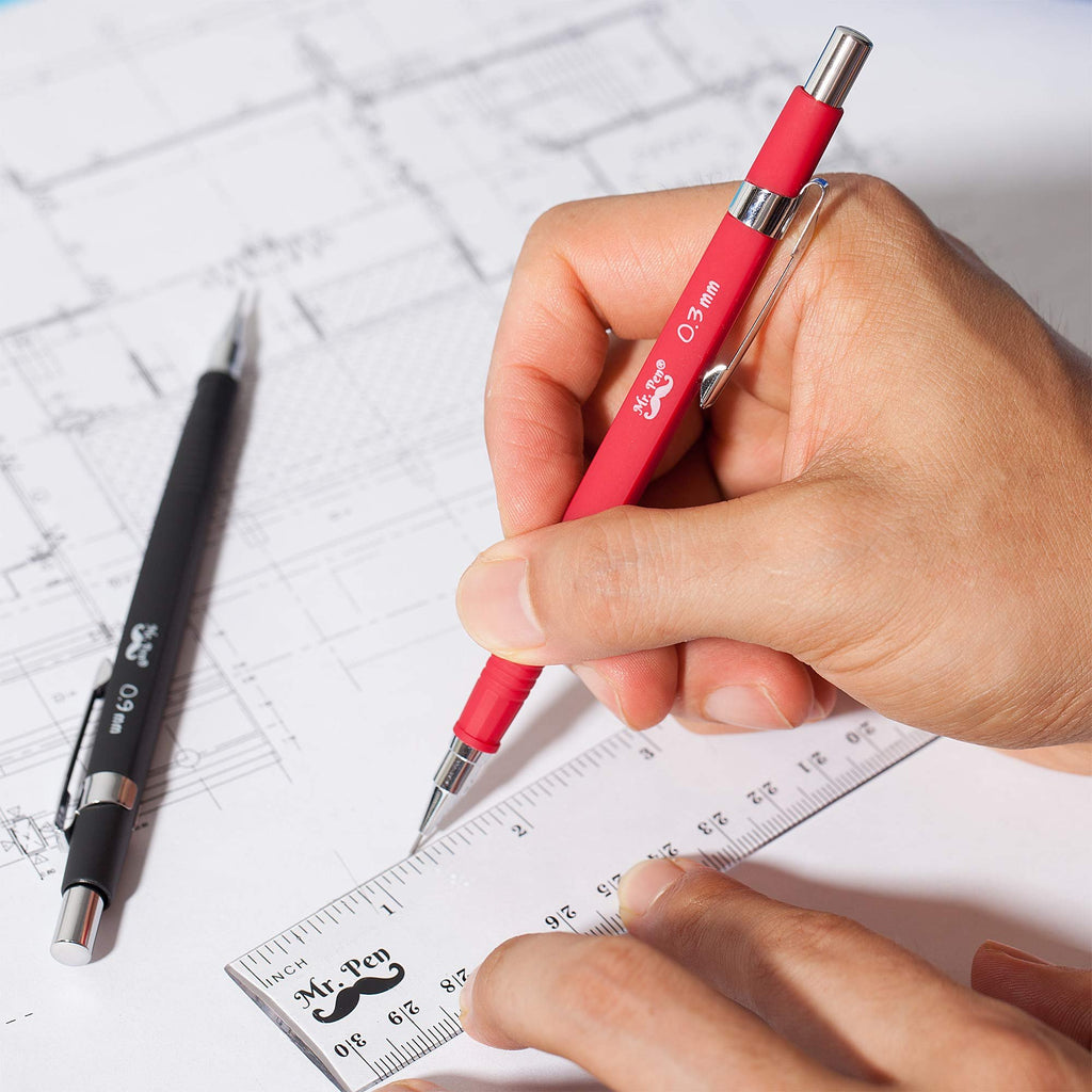 Hands using a red and black mechanical pencil set with a ruler on blueprints. The red pencil is labeled 0.3mm and the black pencil is labeled 0.9mm.