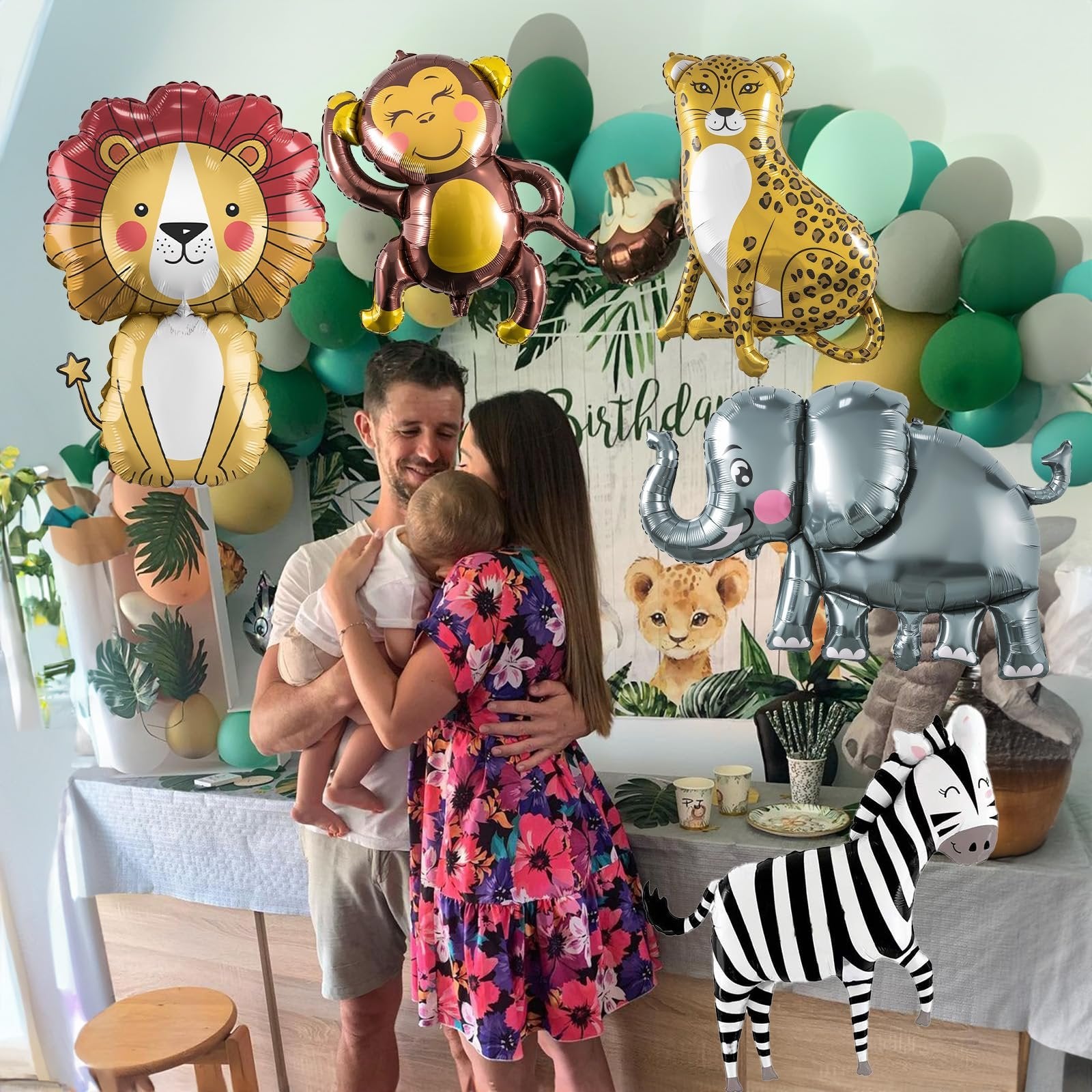 Family celebrating a birthday with safari animal balloons including lion, monkey, leopard, elephant, and zebra.