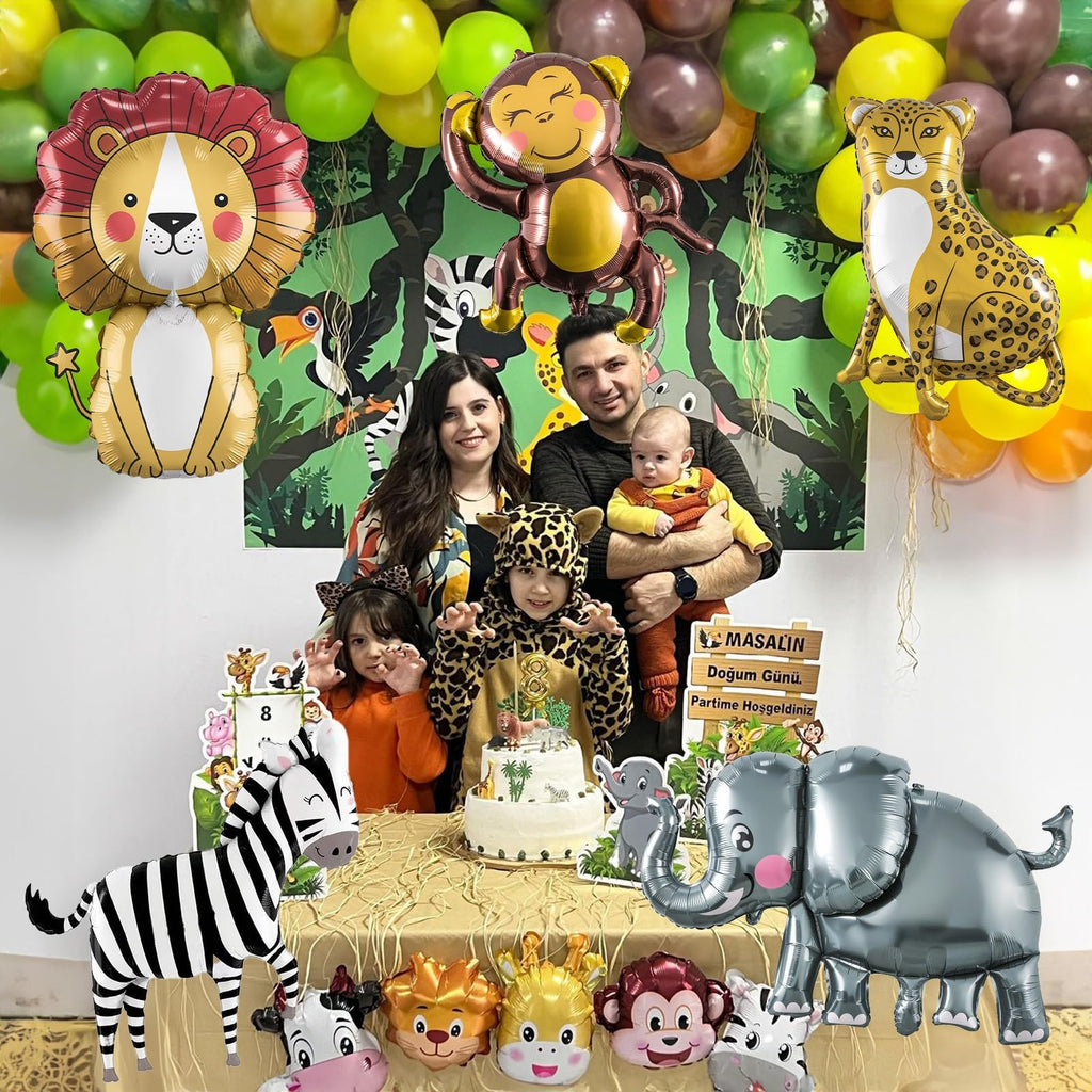 Family celebrating a safari-themed birthday with animal balloons and a cake