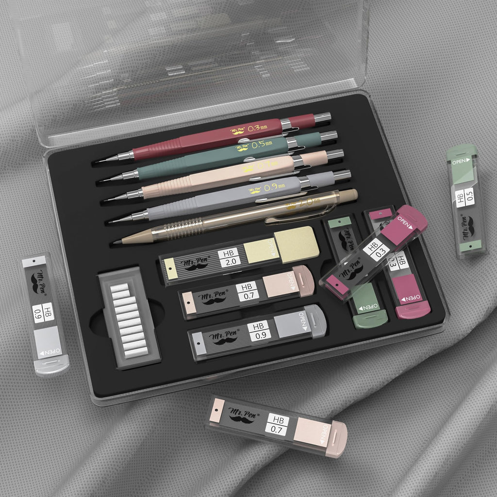 Set of five vintage mechanical pencils in various colors with lead and eraser refills in a clear case.