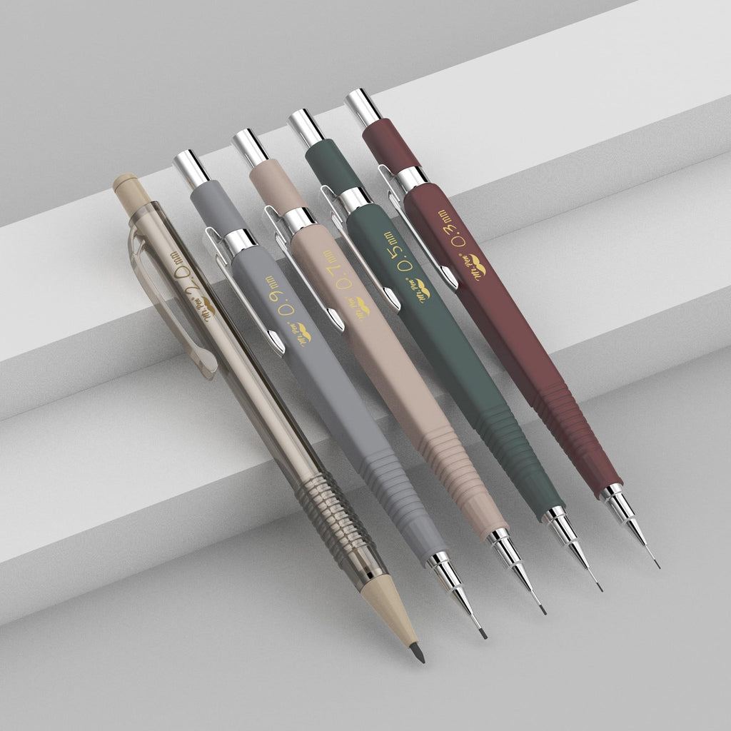 Set of five vintage mechanical pencils with different lead sizes displayed on a light gray surface.