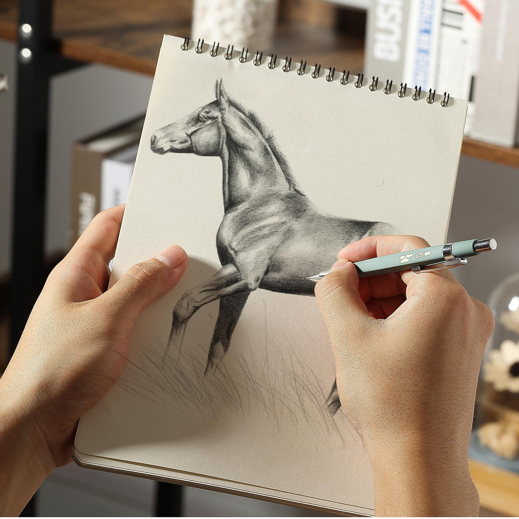 Hands drawing a horse on a spiral-bound sketchbook with a mechanical pencil