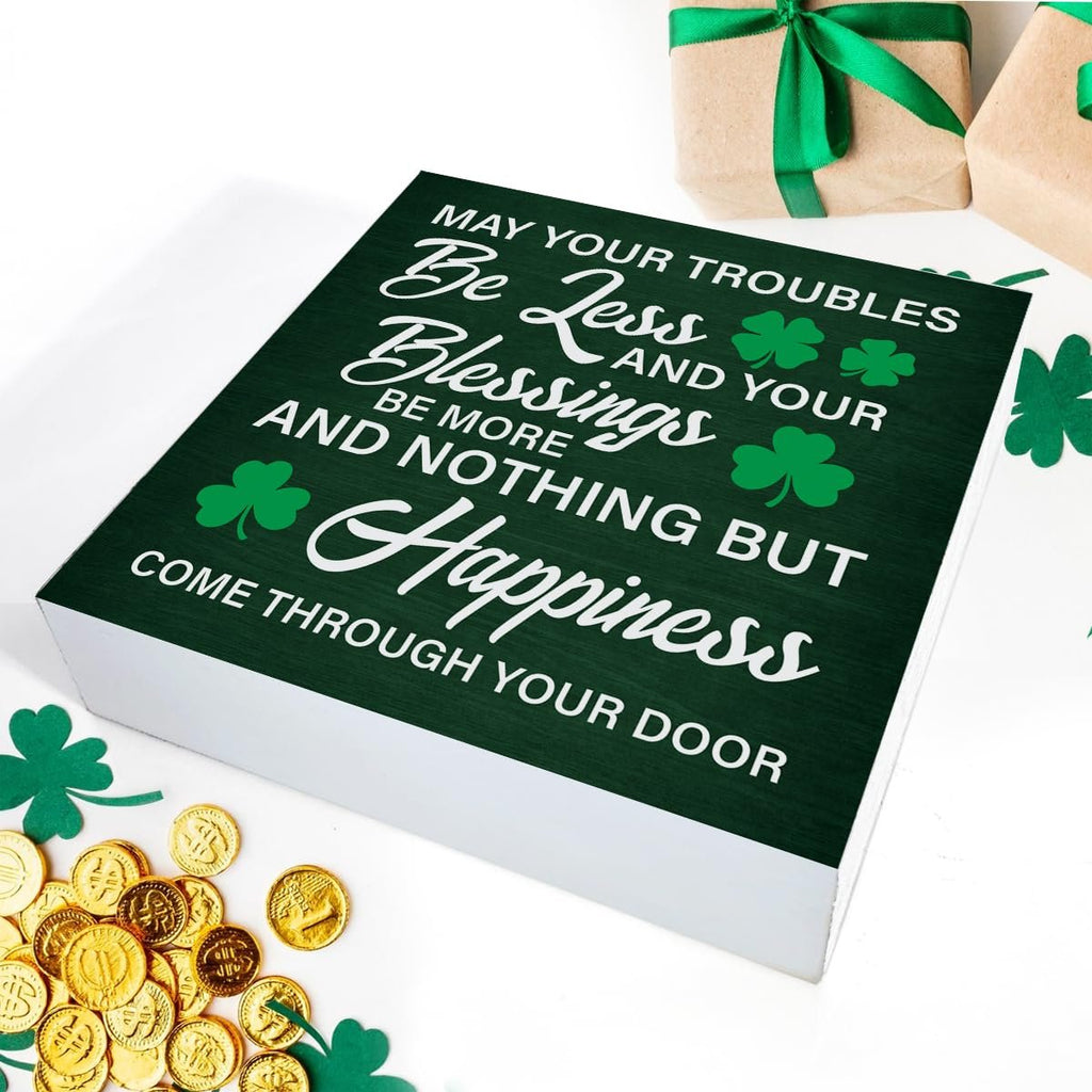 Green wooden St. Patrick's Day sign with Irish blessing and shamrocks, surrounded by gold coins and gift boxes.