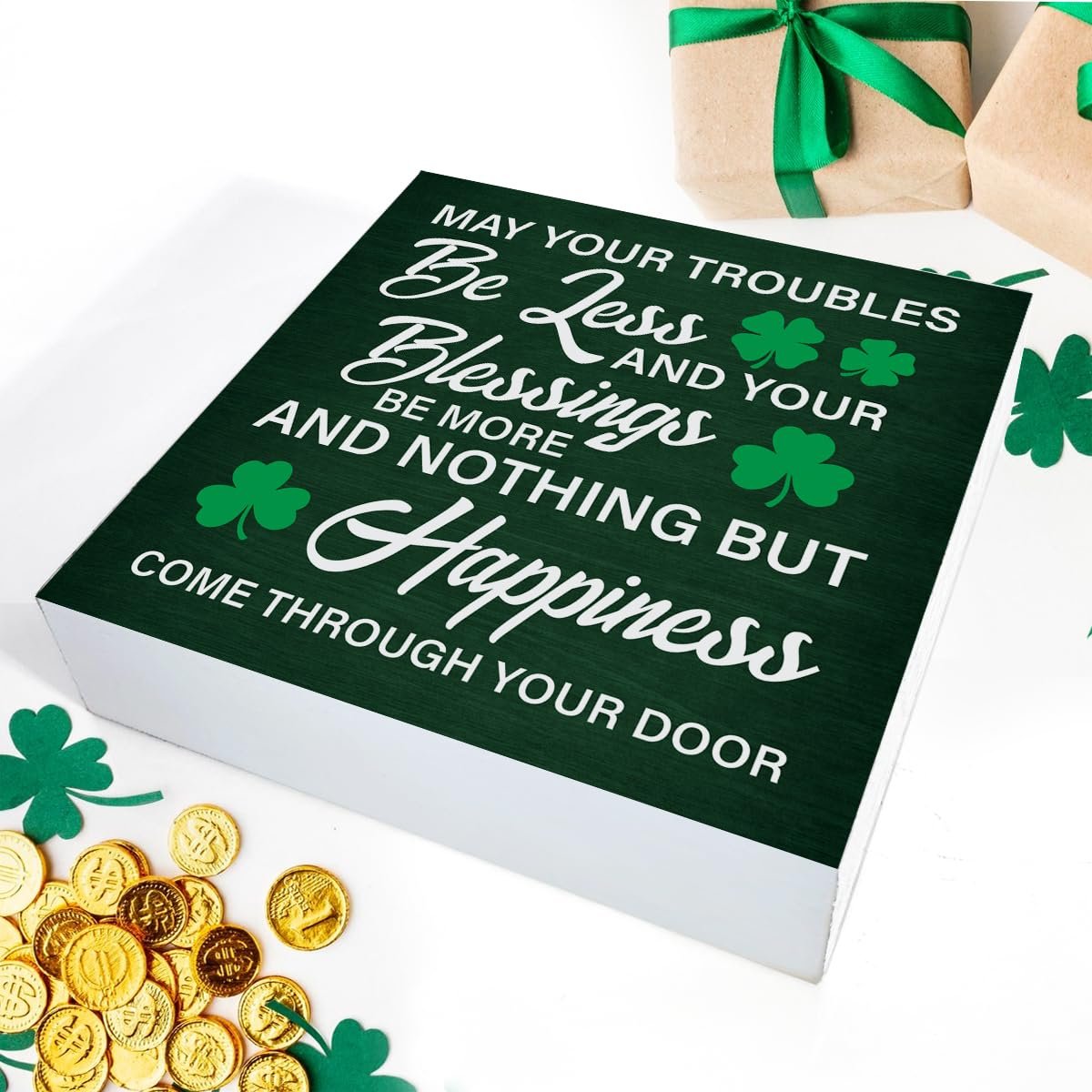 Green wooden St. Patrick's Day sign with Irish blessing and shamrocks, surrounded by gold coins and gift boxes.