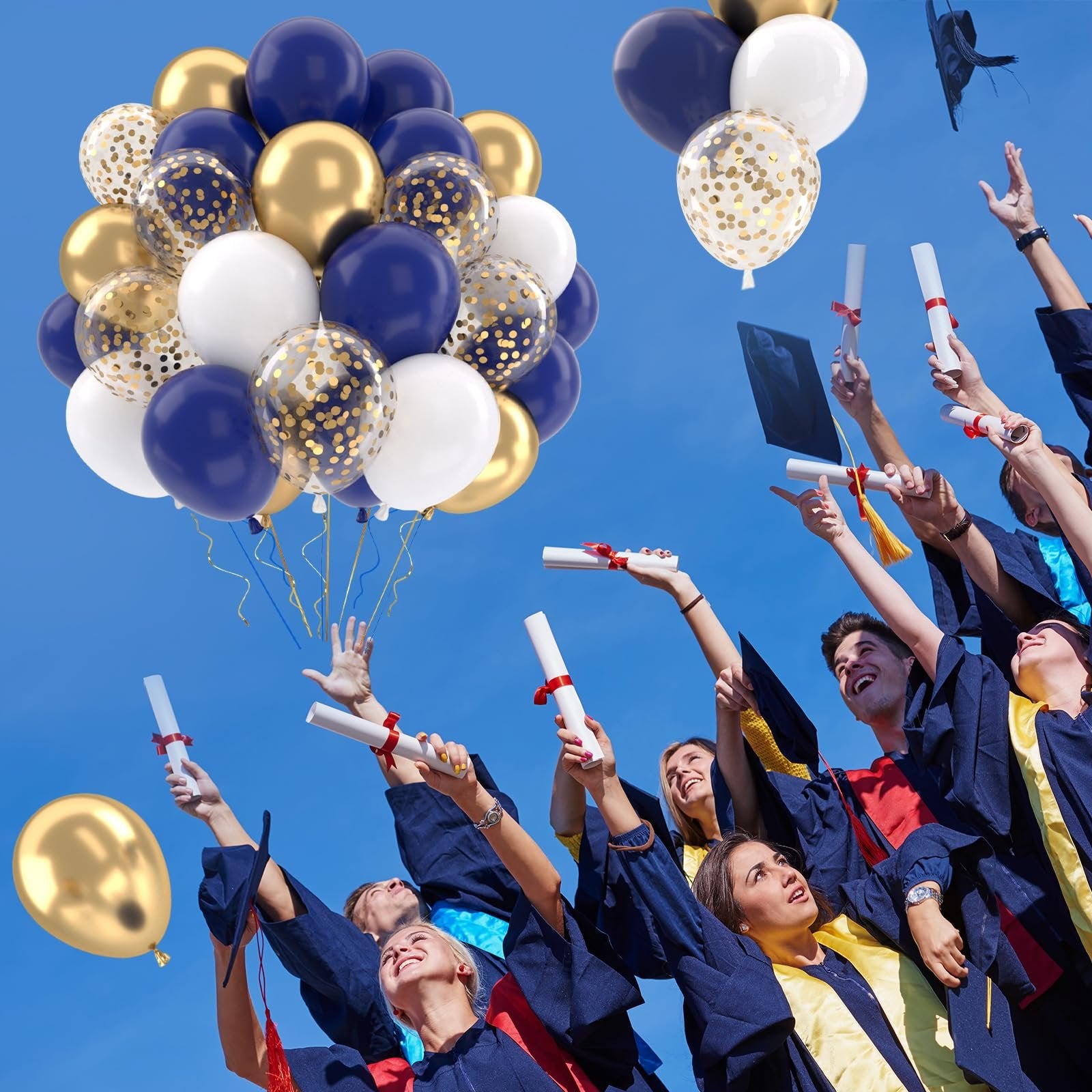 Graduates in caps and gowns throwing diplomas and balloons in the air against a blue sky