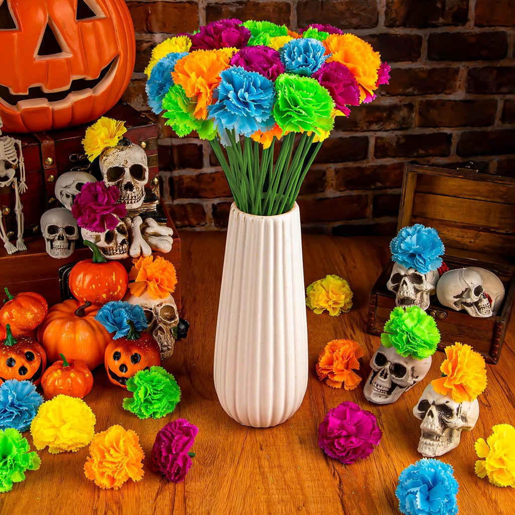 Artificial marigold flowers in a vase with Halloween decorations including pumpkins and skulls