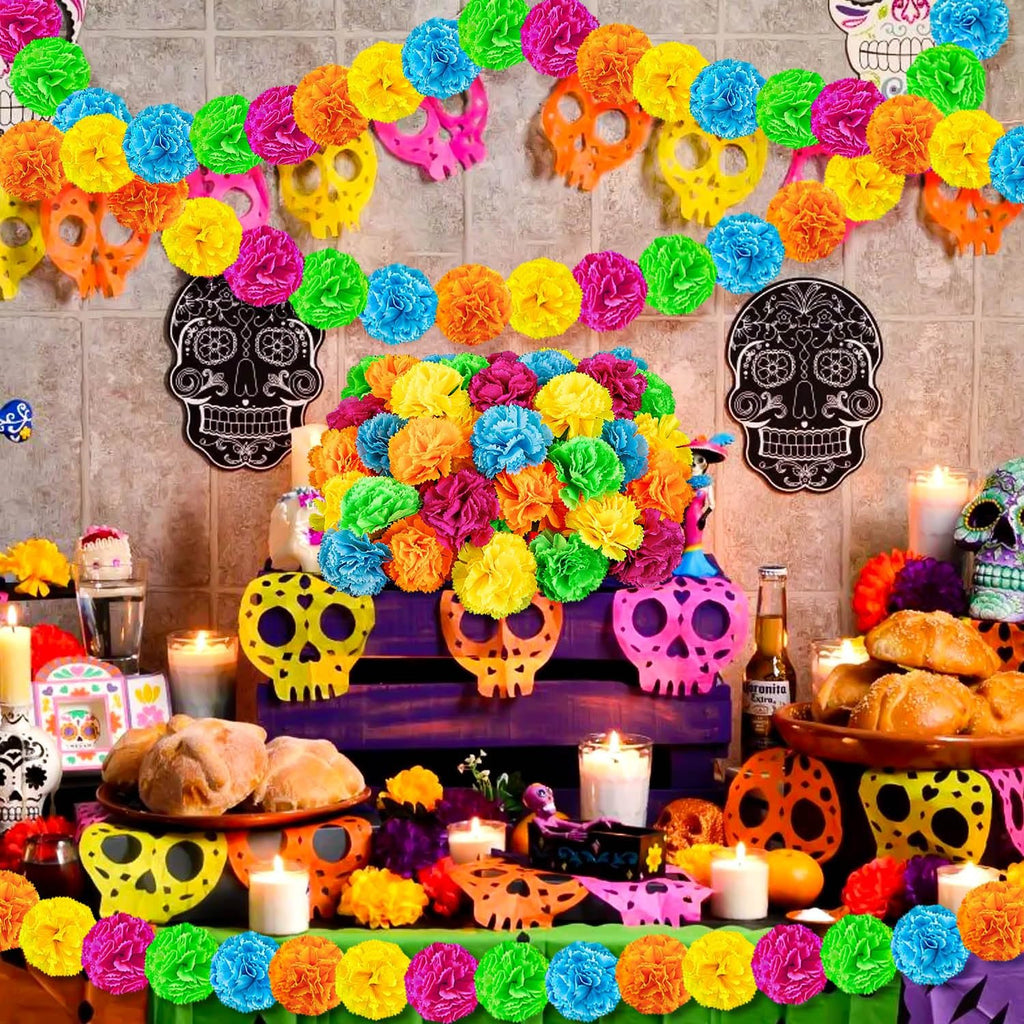Day of the Dead altar with colorful marigold flower garlands, skull decorations, bread, and candles.