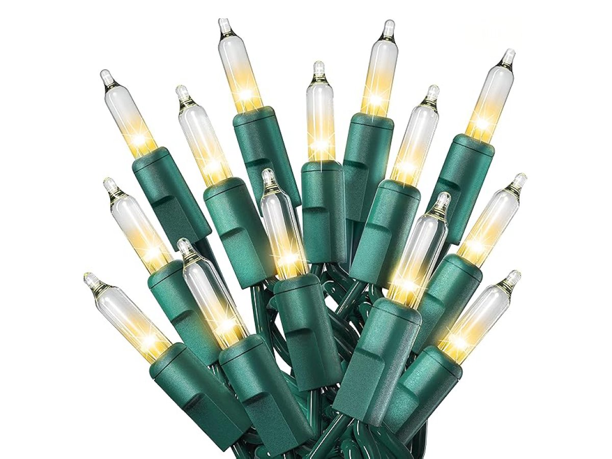 Cluster of 50 count warm white mini Christmas lights with green wire on a white background.