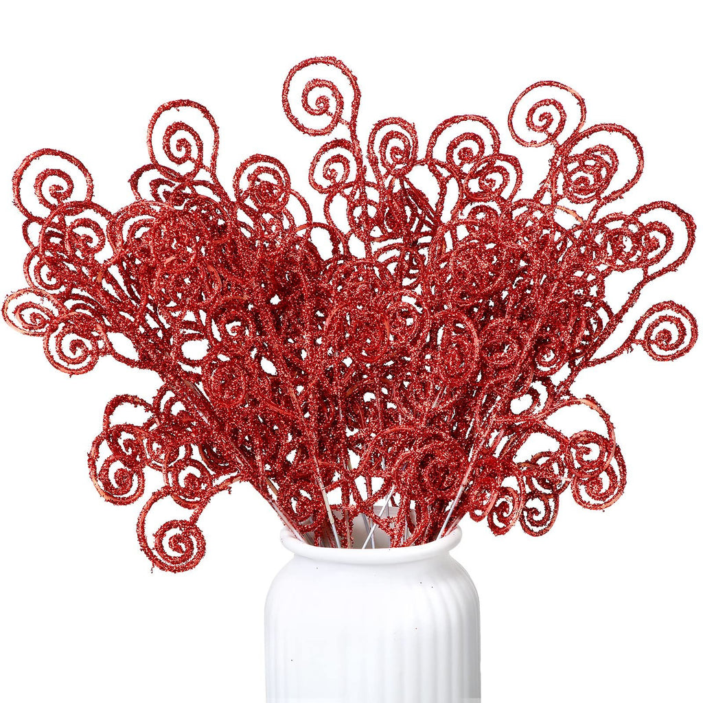 A bunch of red glitter curly twig picks in a white vase against a white background.