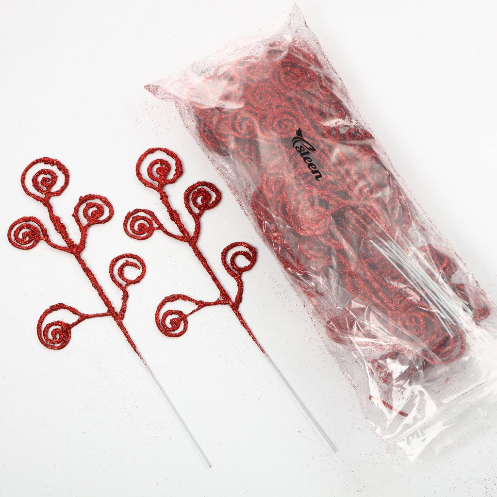 Two red glitter curly twig picks next to a clear plastic bag filled with more red glitter curly twigs on a white background.