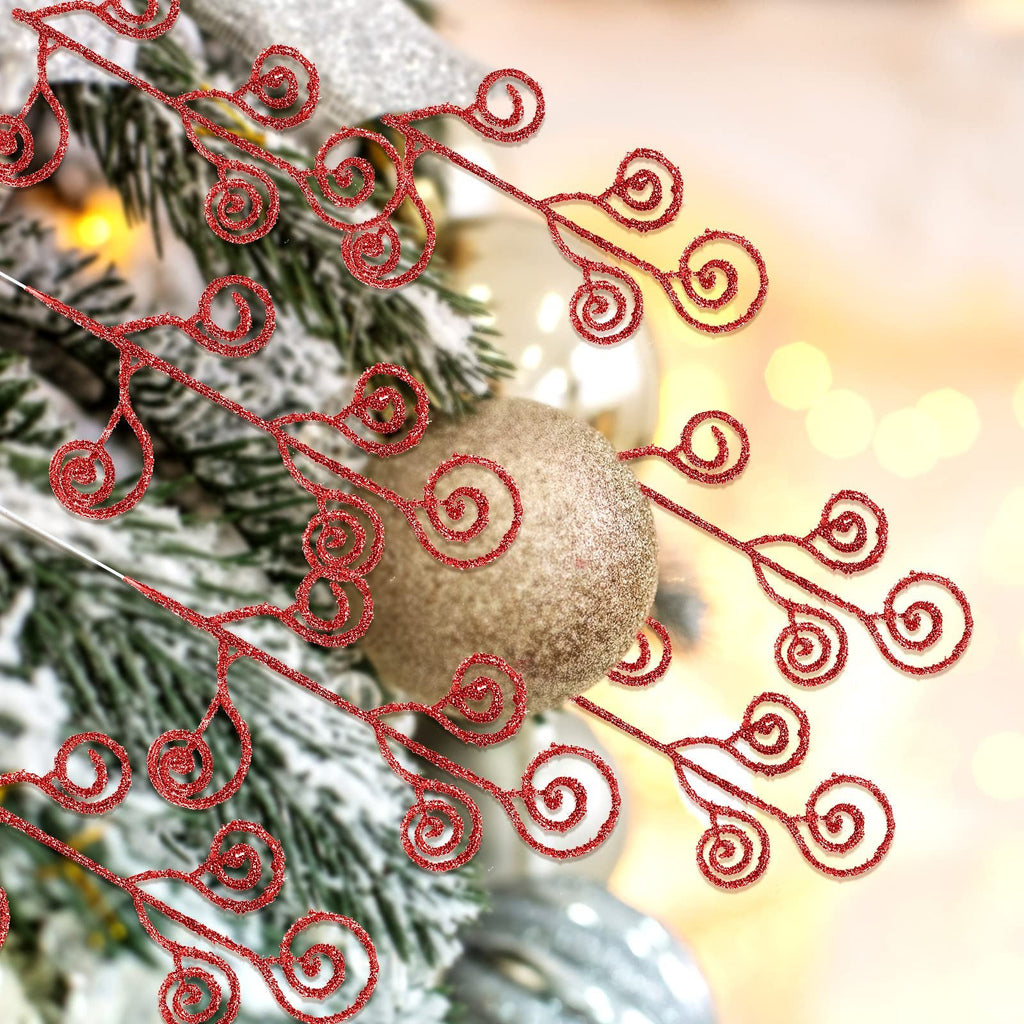 Close-up of red glitter curly twig picks on a frosted Christmas tree with gold ornaments.