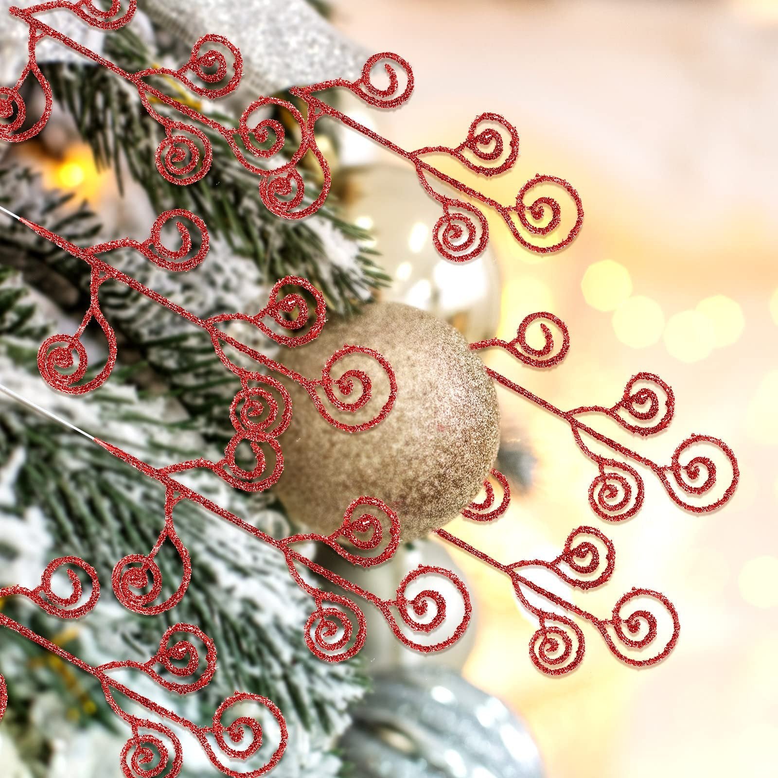 Close-up of red glitter curly twig picks on a frosted Christmas tree with gold ornaments.