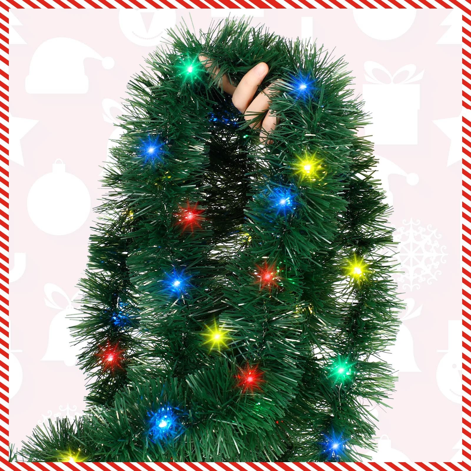 Green Christmas tinsel garland with multi-colored LED lights, held by a hand, with festive icons on a pink background.