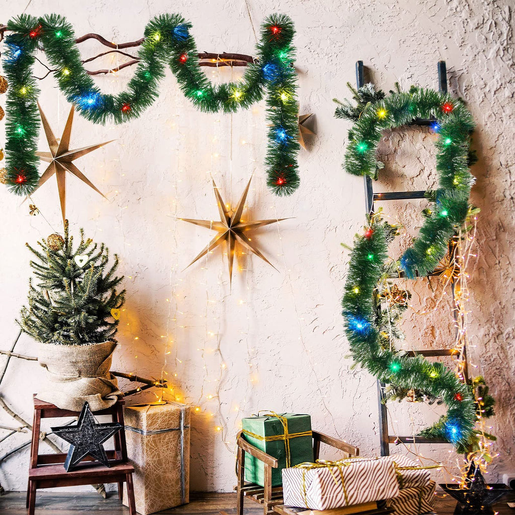 Christmas tinsel garland with colorful LED lights draped on branches and a ladder, with a small decorated tree and wrapped gifts.