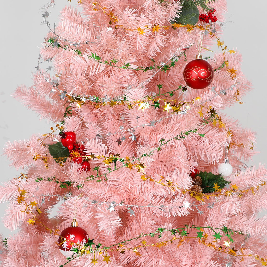 Pink Christmas tree decorated with gold and silver star tinsel garland and red ornaments.
