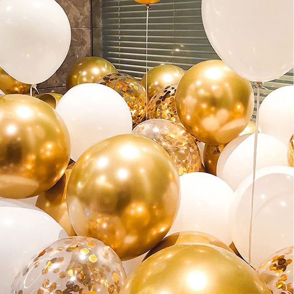 Close-up of a large cluster of white and gold balloons, some filled with gold confetti.