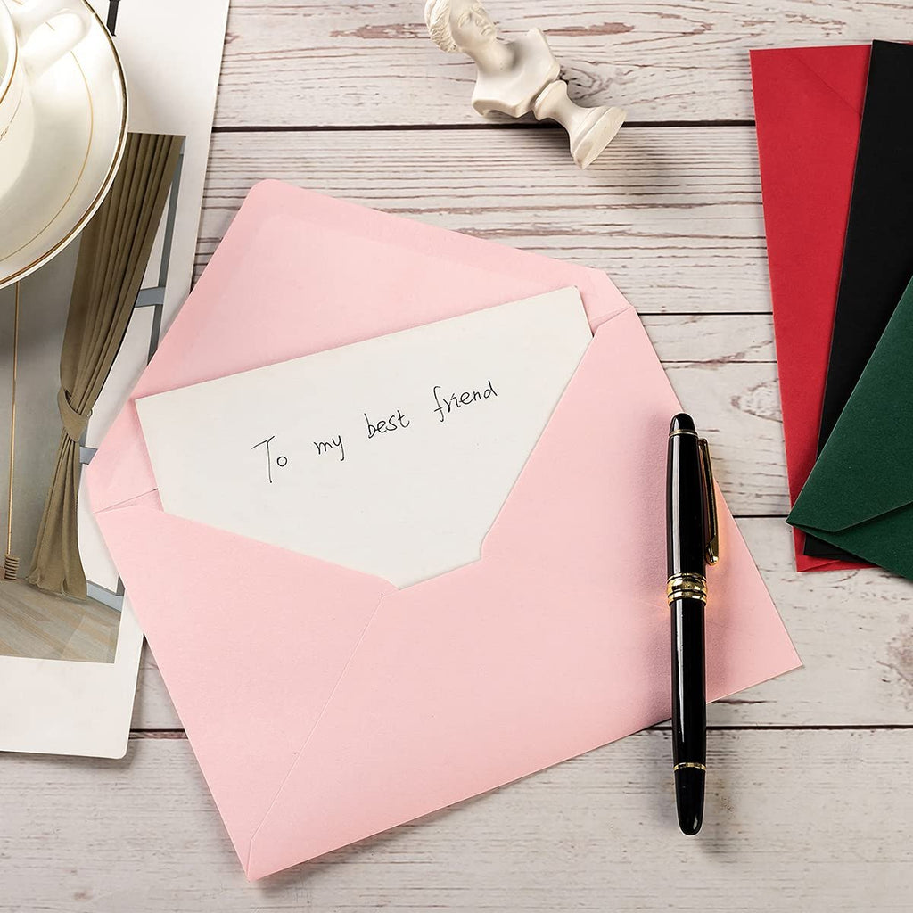 Pink A7 envelope with a card inside that says 'To my best friend', next to a pen and other colored envelopes.