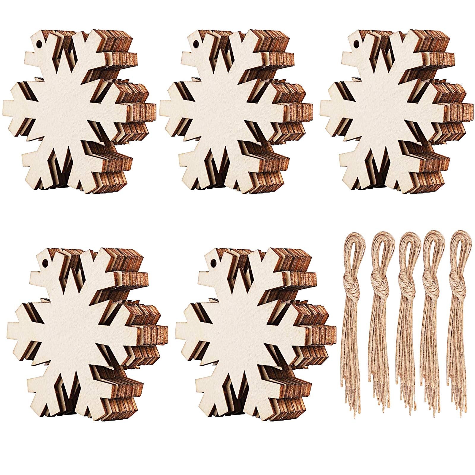 Stacks of unfinished wooden snowflake ornaments and bundles of twine on a white background