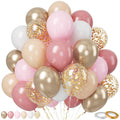 A large cluster of pink, gold, and white balloons, some filled with gold confetti, against a white background.