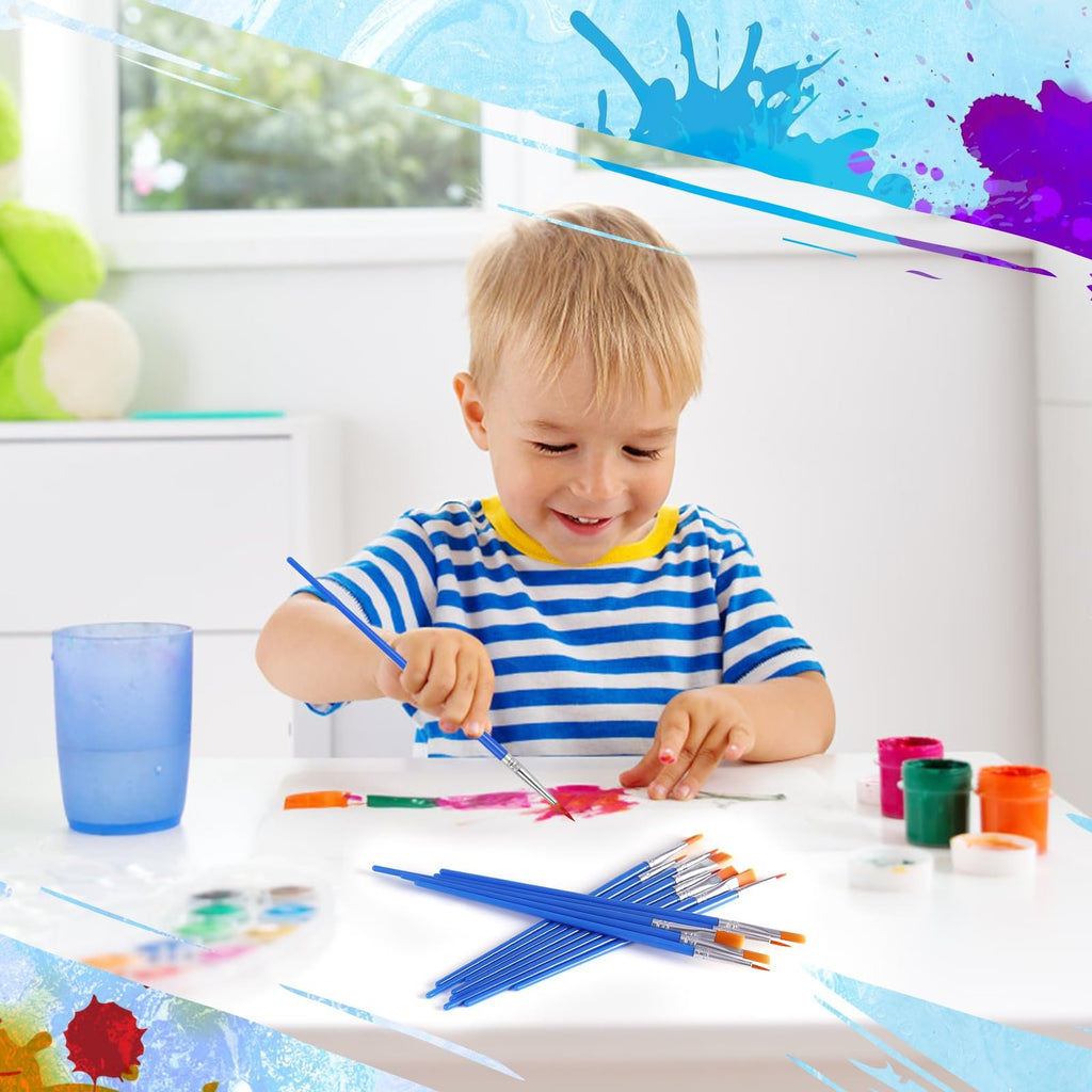 Young boy painting with blue handled brushes and colorful paints on white paper