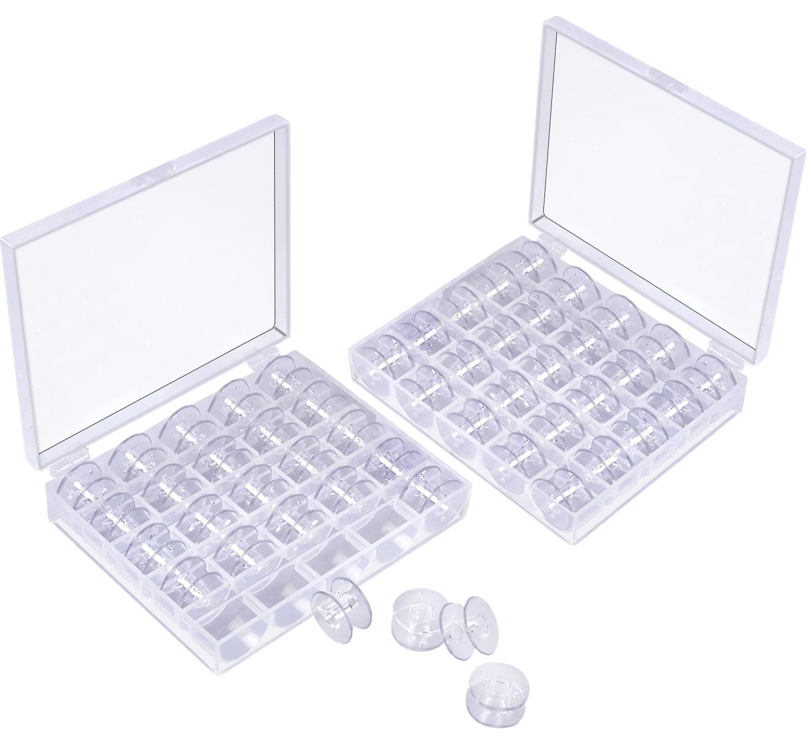 Two clear plastic storage cases filled with transparent sewing machine bobbins, with a few bobbins outside the cases.