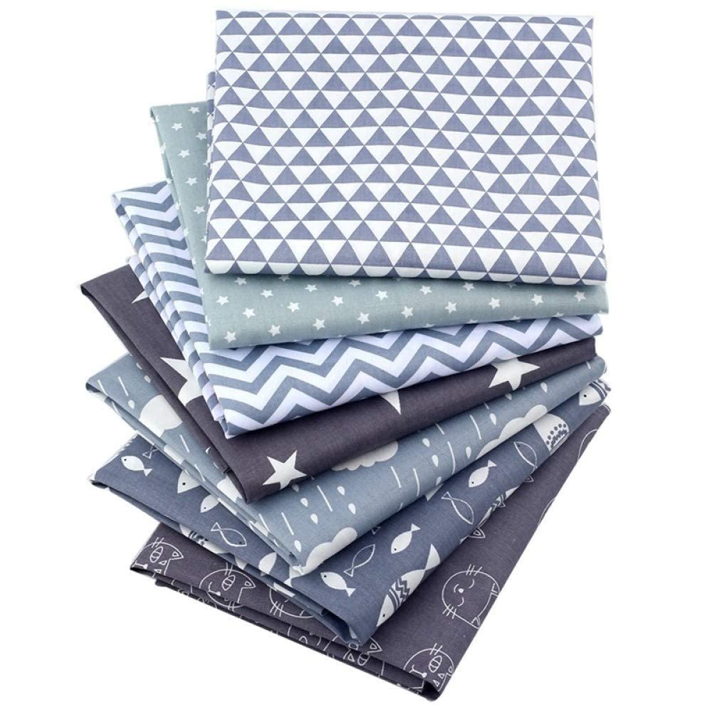 Stack of 100% cotton fabric squares with various patterns including triangles, stars, zigzags, and sea creatures.