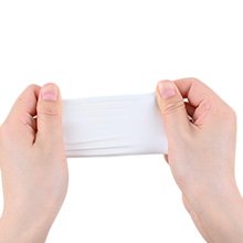 Hands stretching a white fabric swatch against a white background