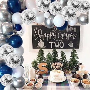 Balloon arch with navy blue, pearl white, silver, and confetti balloons over a birthday party table setting.