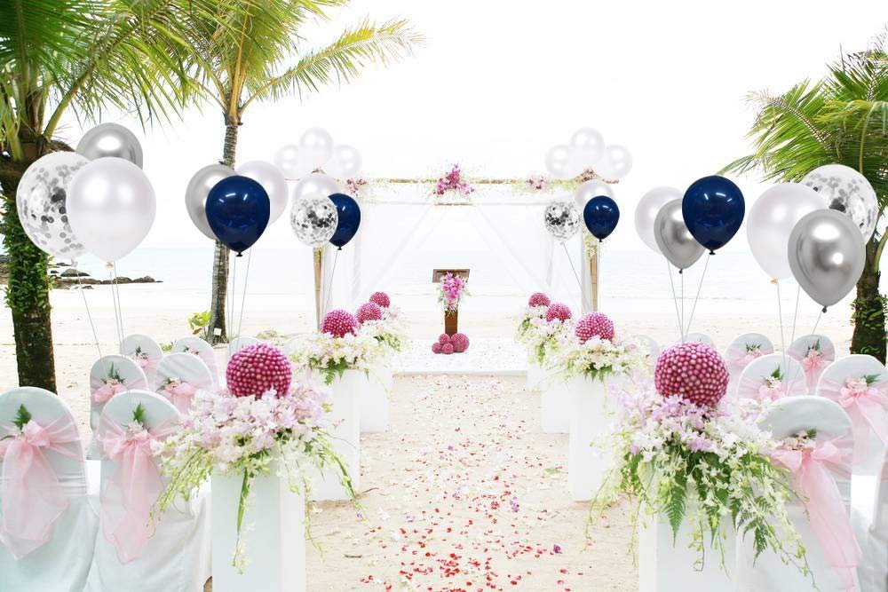 Beach wedding aisle decorated with flowers and balloons, featuring navy blue, pearl white, silver, and confetti balloons.