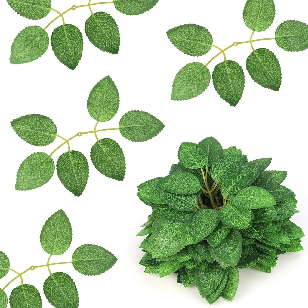 Artificial green rose leaves with plastic stems on a white background, showing several individual stems and a cluster of leaves.