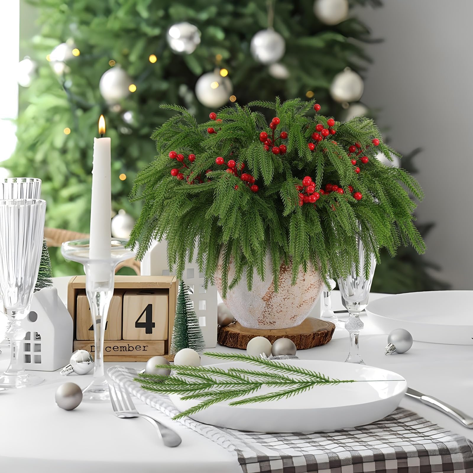Christmas table setting with artificial pine centerpiece, candle, and December 4th calendar blocks.