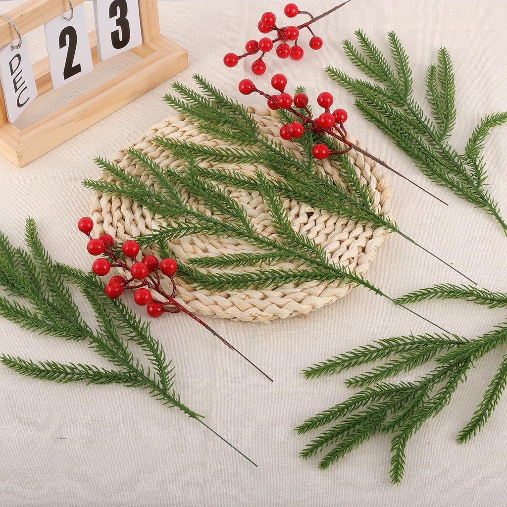 Artificial pine branches with red berries and a wooden calendar showing December 23rd