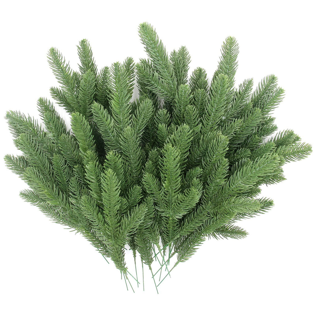 Artificial pine branches with green plastic needles, displayed on a white background.