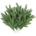Artificial pine branches with green plastic needles, displayed on a white background.