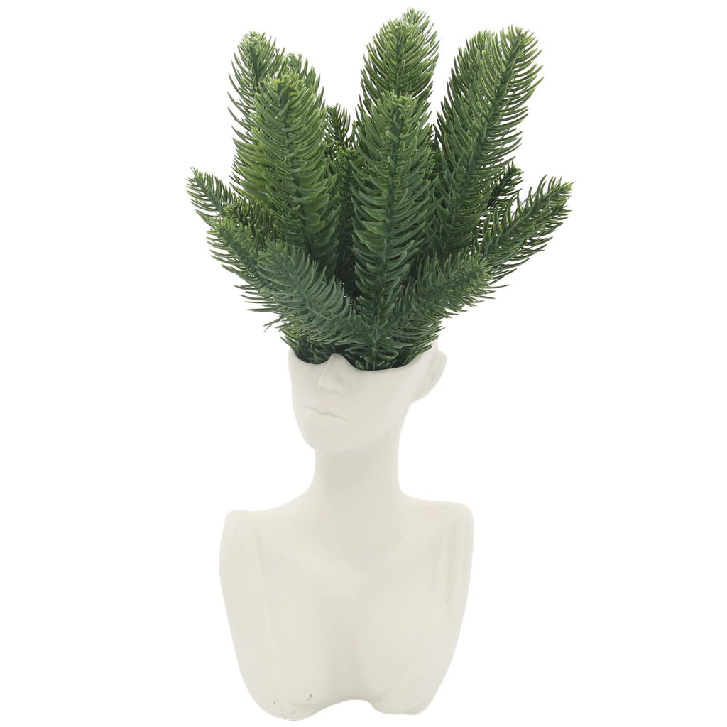 White bust planter with green artificial pine branches emerging from the top