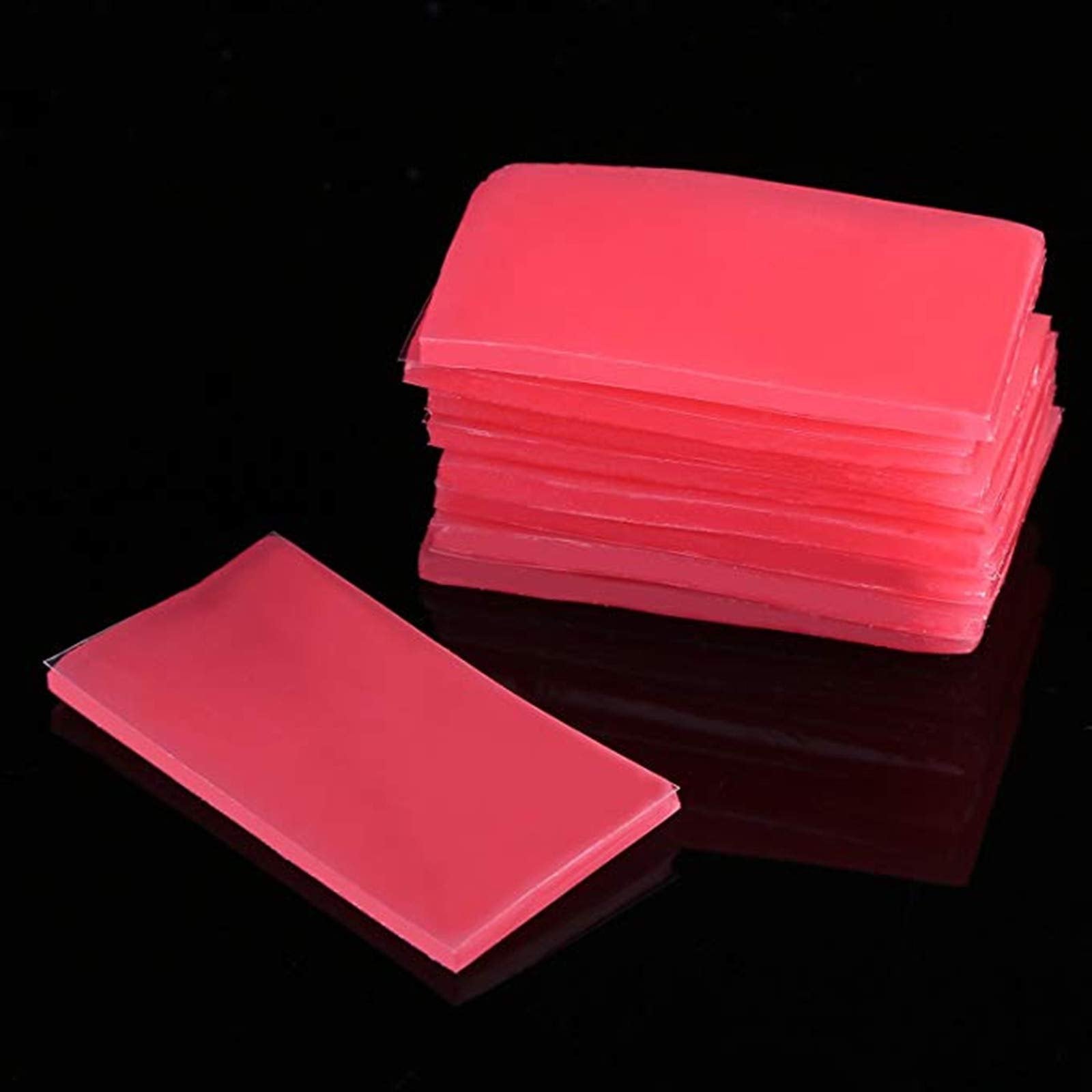 Stack of watermelon red diamond painting wax clay pieces on a black background