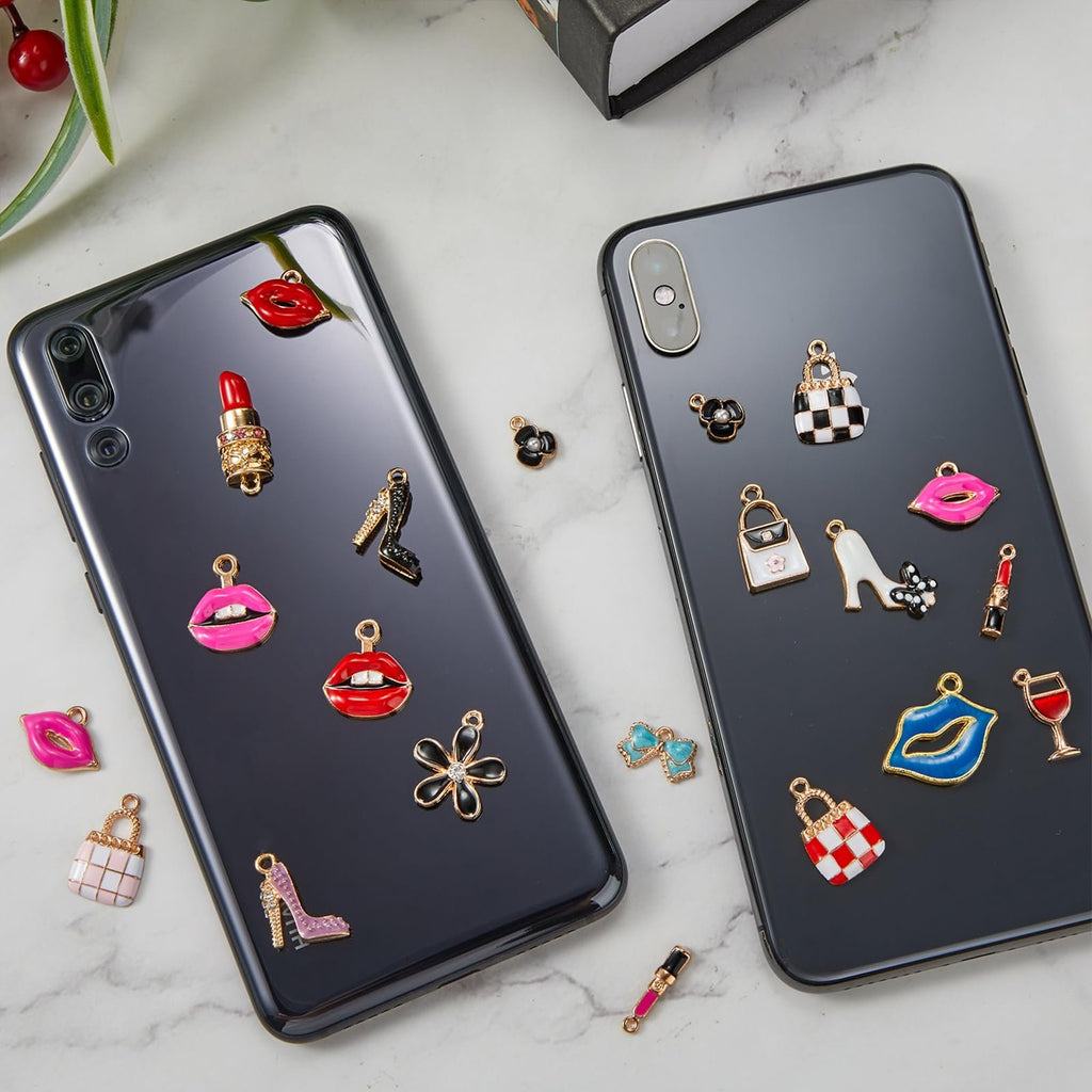 Assortment of fashion-themed enamel charms displayed on the backs of two smartphones.
