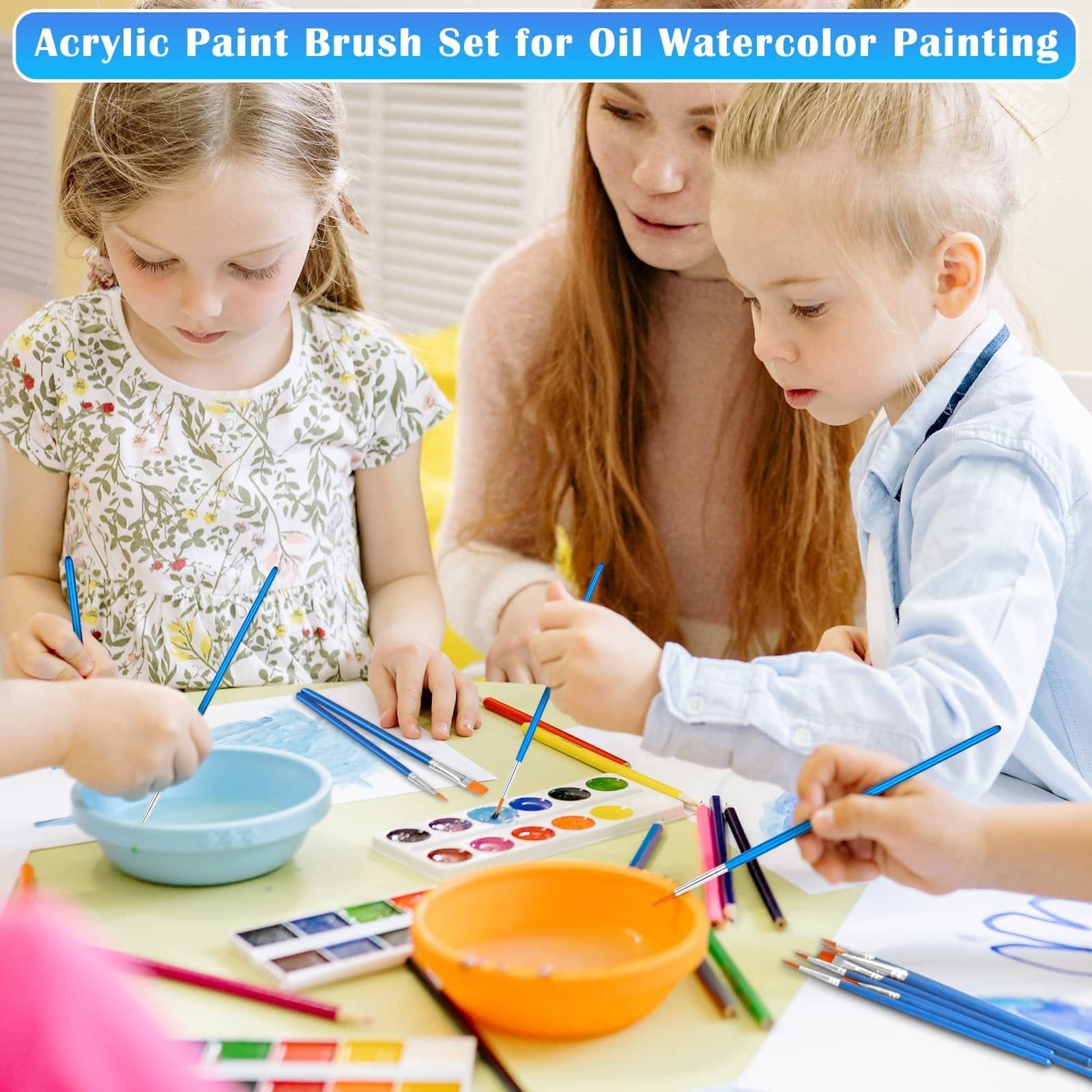 Children and adult painting with brushes and watercolors at a table