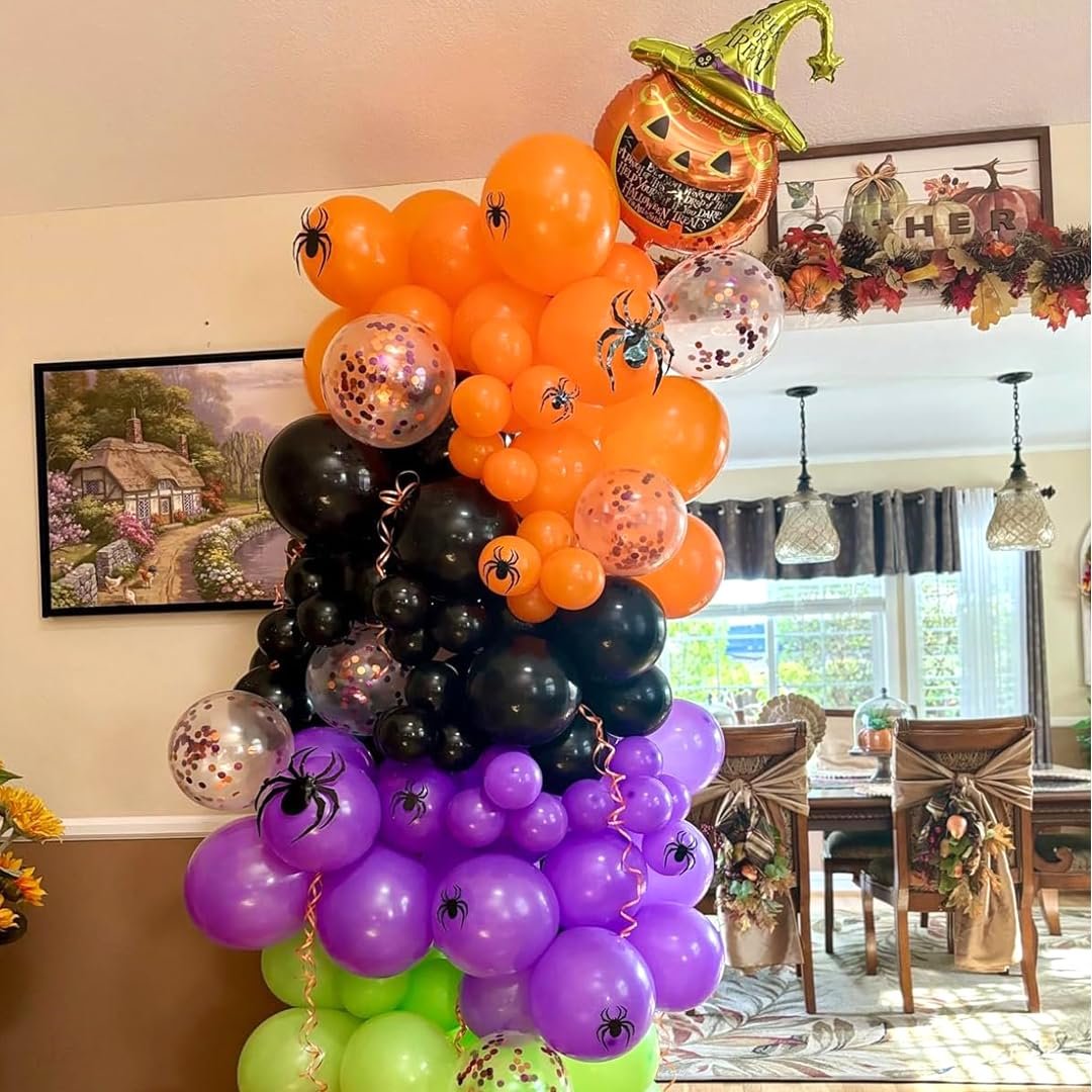 Halloween balloon arch with black, orange, purple, and green balloons, featuring a pumpkin foil balloon and spider decorations.