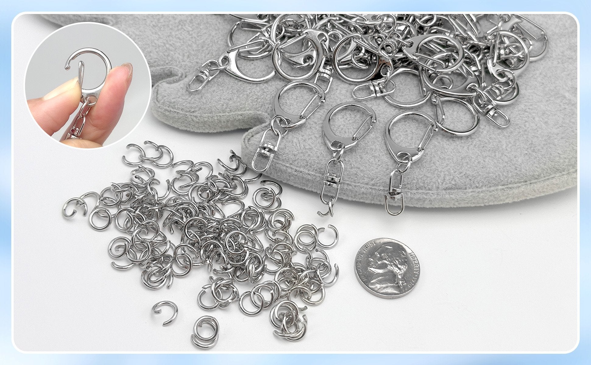 Close-up of metal lobster claw clasps and jump rings for DIY keychains, with a coin for scale.