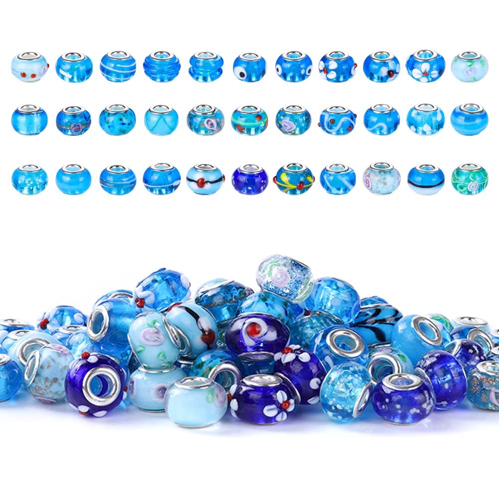 Aqua Murano style large hole rondelle glass beads with brass cores, arranged in two rows and a pile.