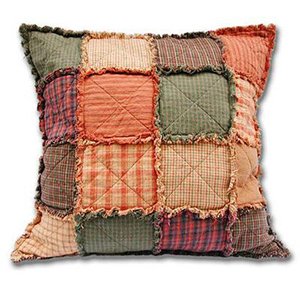 Patchwork throw pillow with frayed edges, featuring squares of various plaid and solid patterns in muted earth tones.