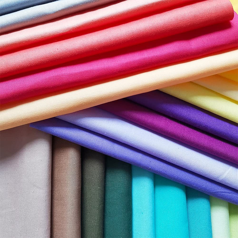 Stack of precut solid color cotton fabric squares in various bright and pastel shades, arranged in diagonal layers.