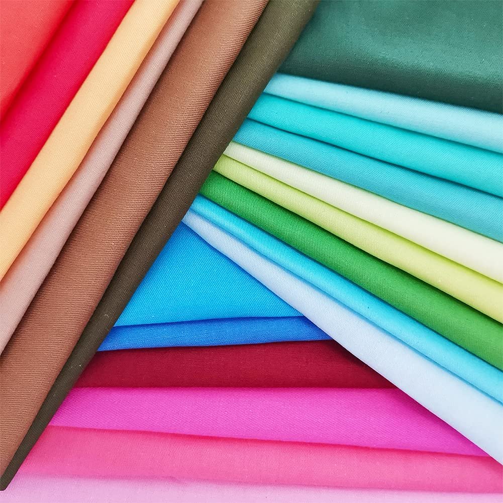 Stack of precut solid color cotton fabric squares in various bright and pastel shades, arranged in a fanned pattern.