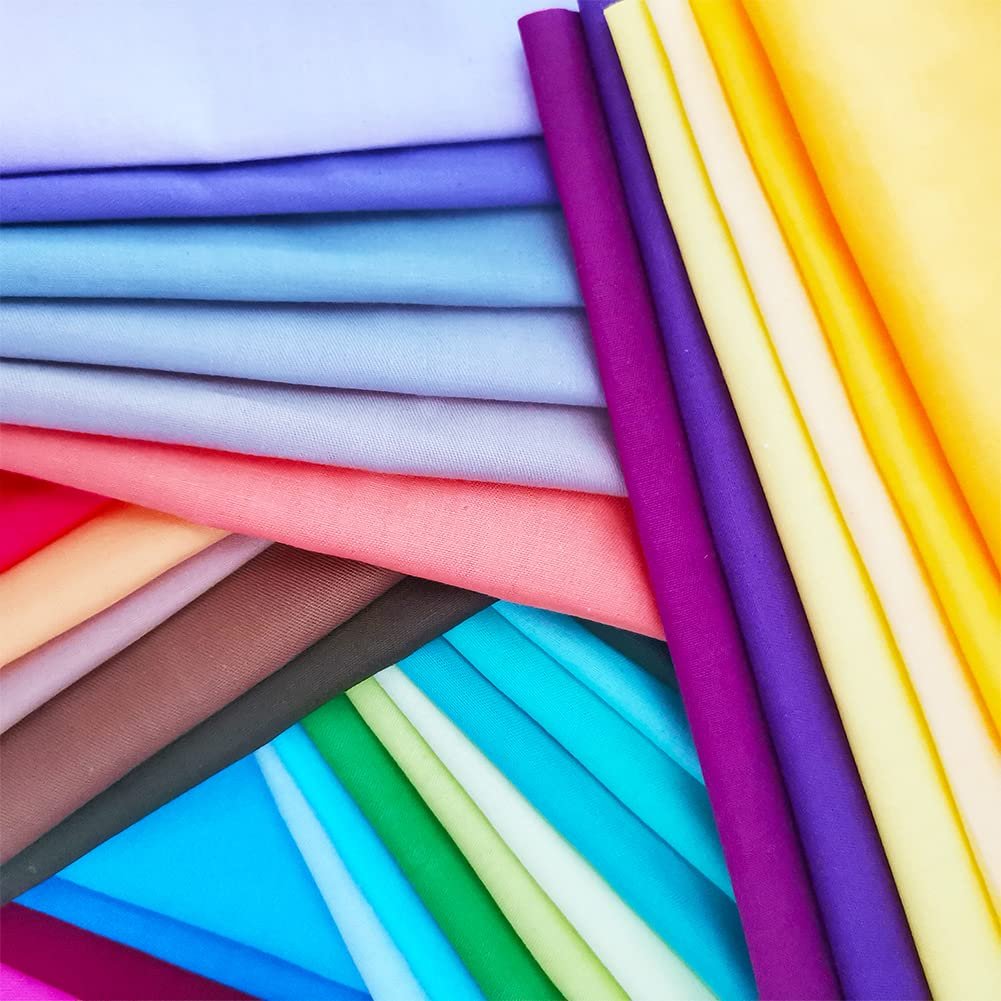 Stack of precut solid color cotton fabric squares in various pastel and bright hues, fanned out.