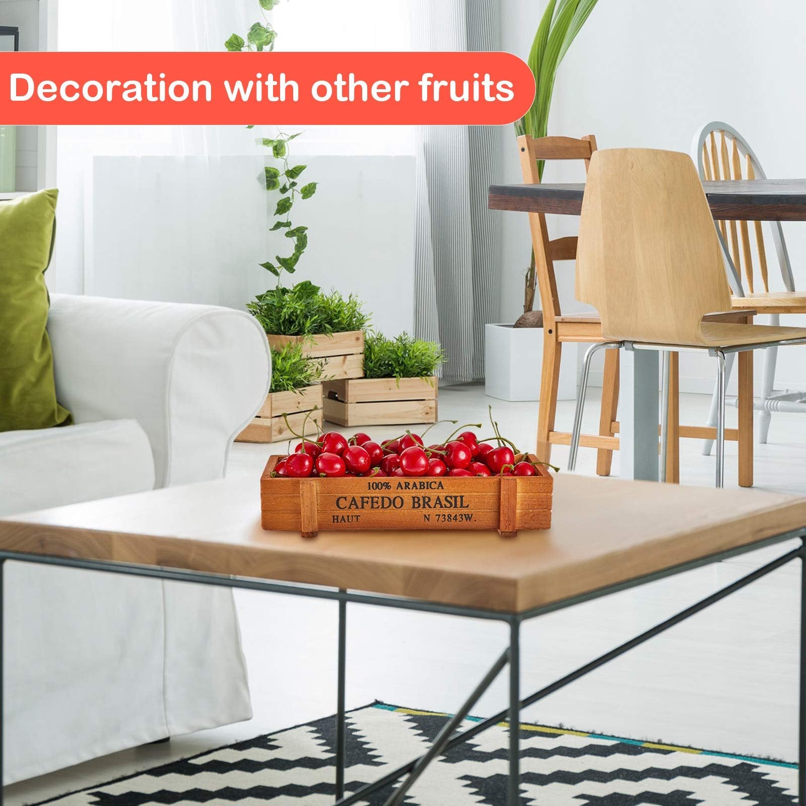 Red artificial cherries in a wooden crate on a coffee table, with a sofa and chairs in the background.