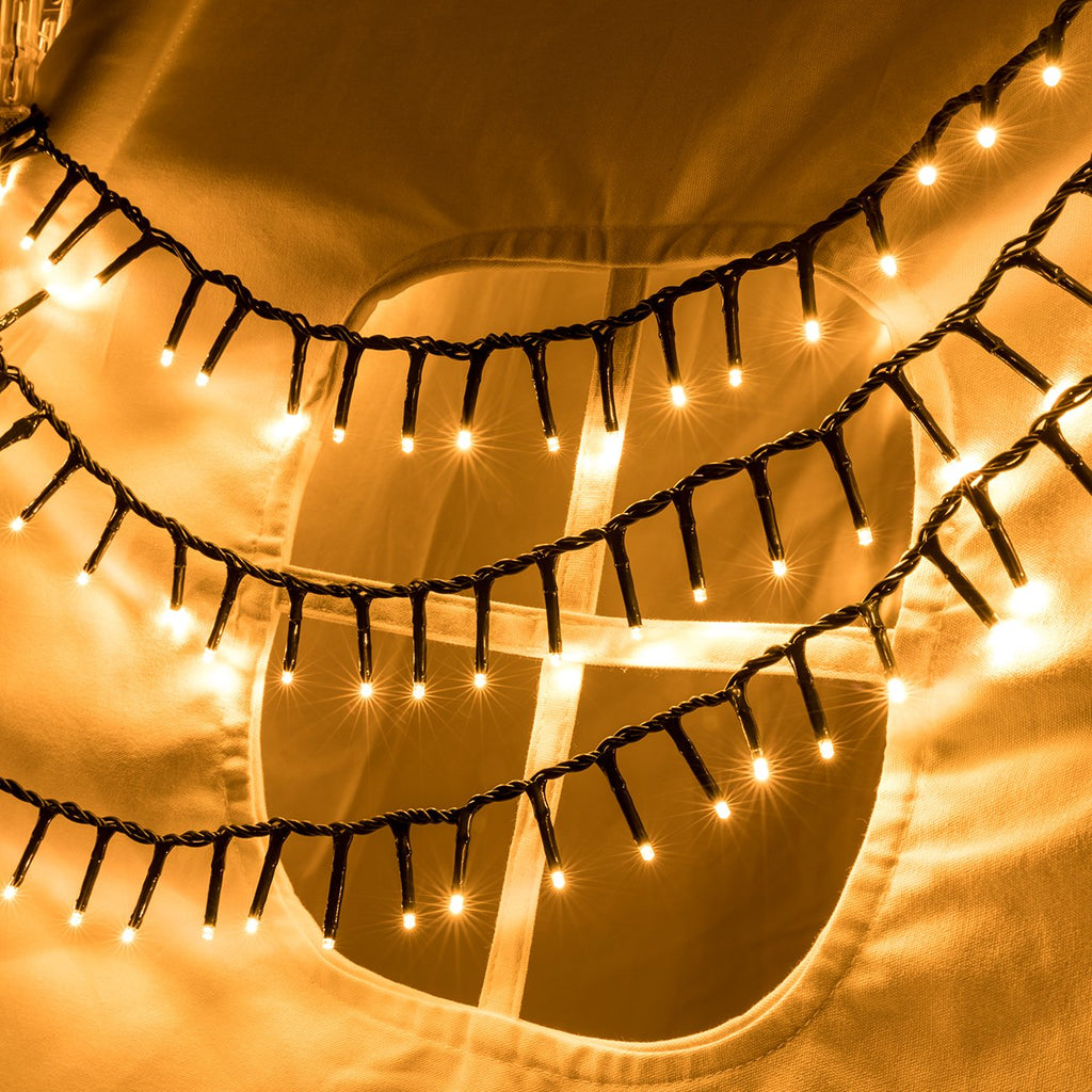 Warm white LED cluster string lights draped over fabric with a circular cutout