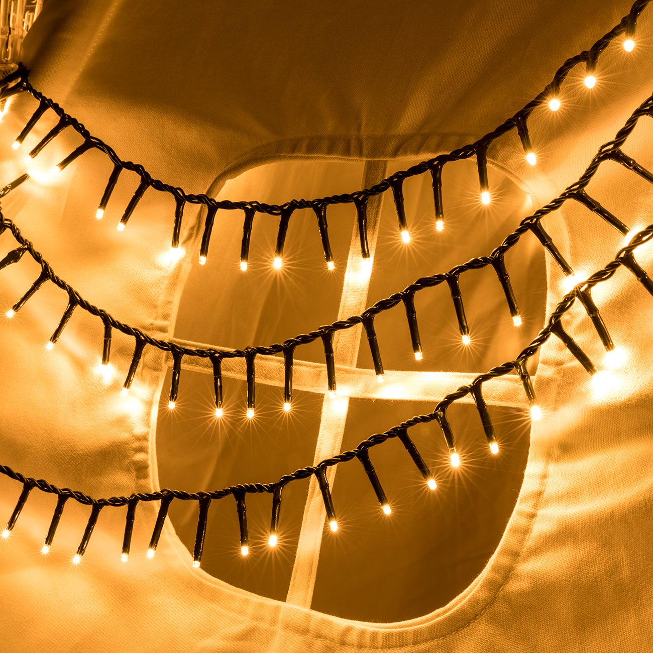 Warm white LED cluster string lights draped over fabric with a circular cutout