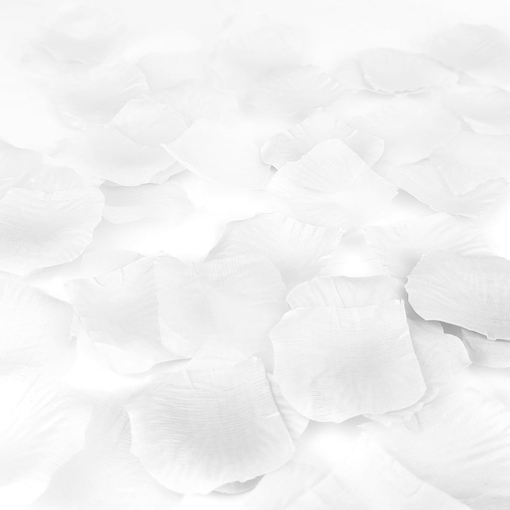 Scattered white artificial rose petals made of silk fabric, close-up view