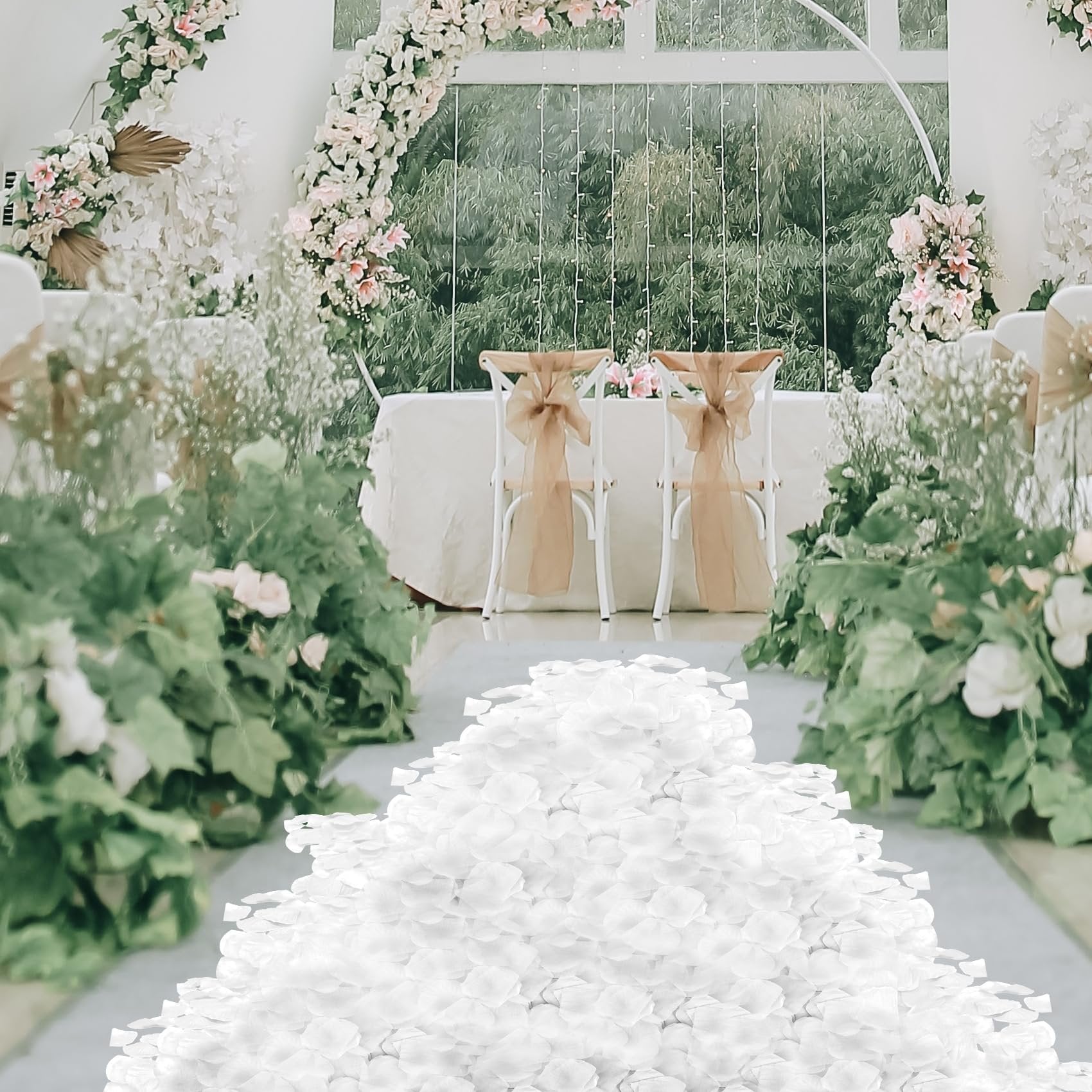 Pile of white artificial rose petals on a wedding aisle with floral decorations and chairs